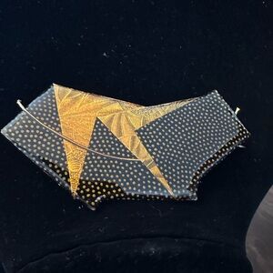 Handcrafted black and gold brooch